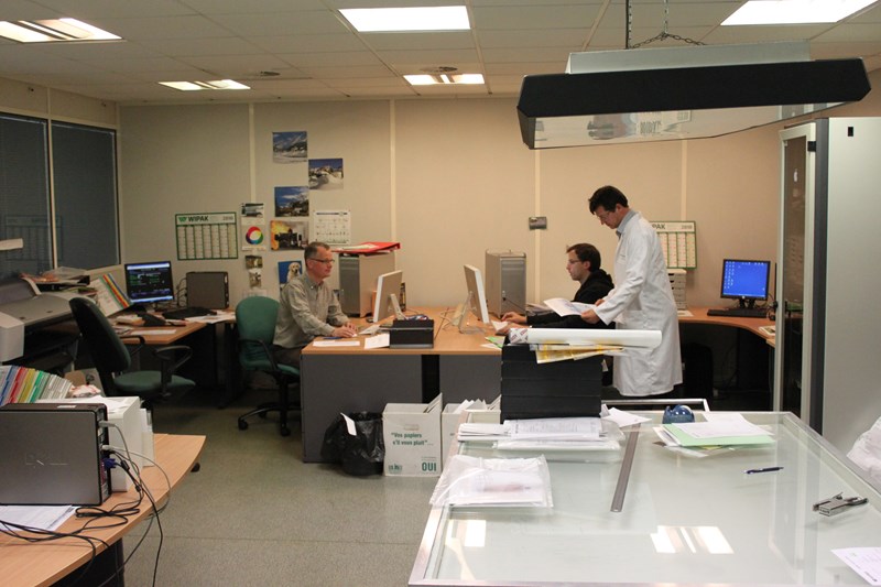 Photo of Wipak employees reviewing prepress operations