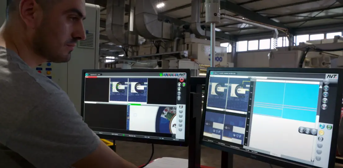 A man working at two monitors