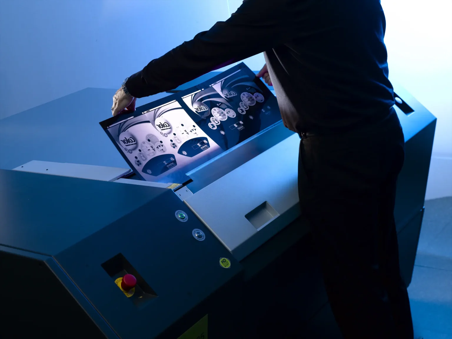 Man in front of large printer