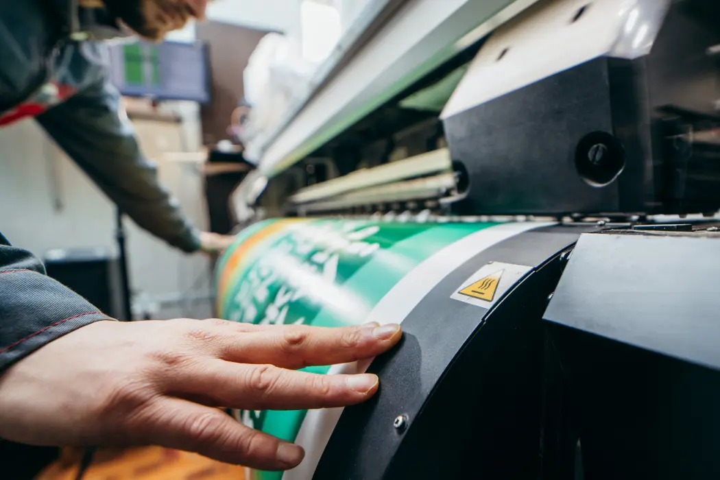 Man working on a large printer