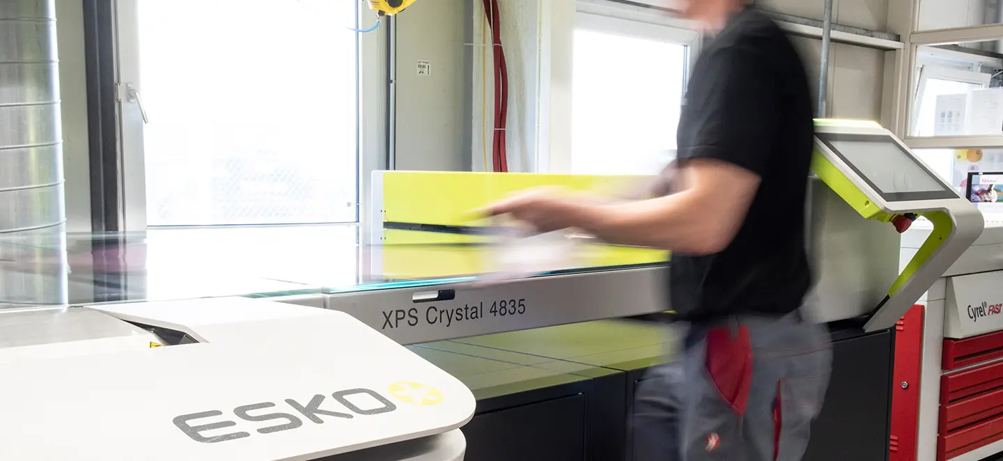 A man at an industrial printer