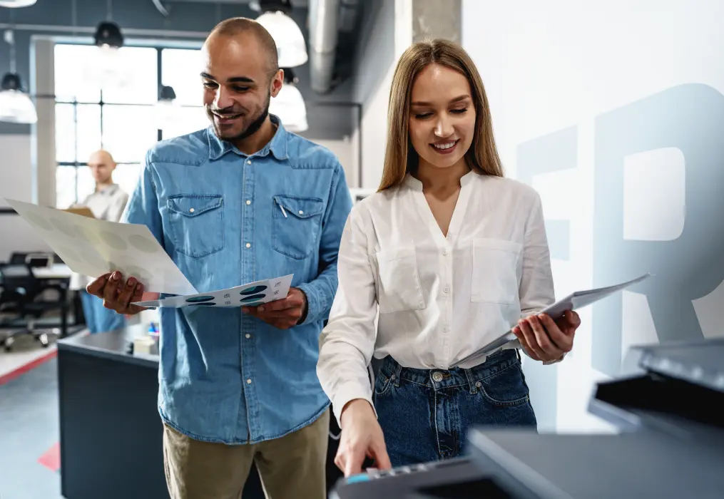 A woman and a man at the printer