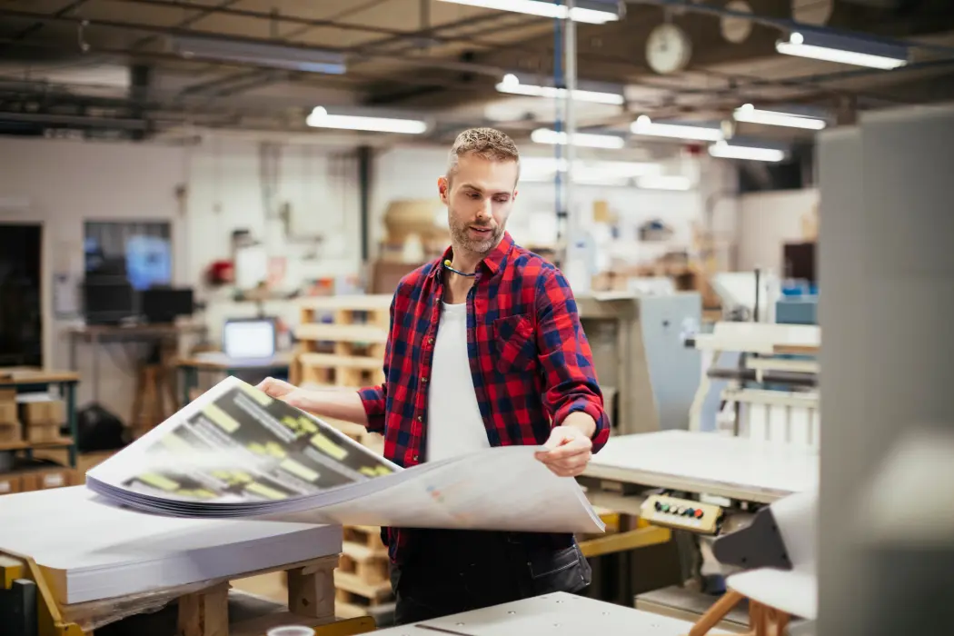 Man with print sheets in hand