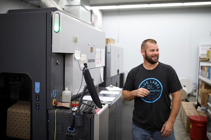 image of man next to a printing press