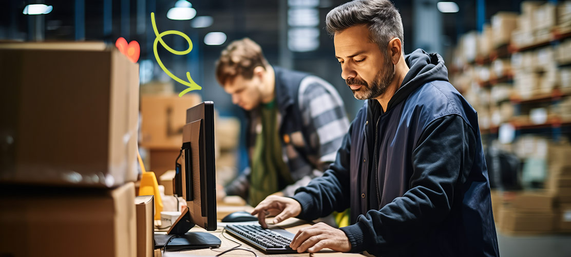 Photo of warehouse operator at a computer