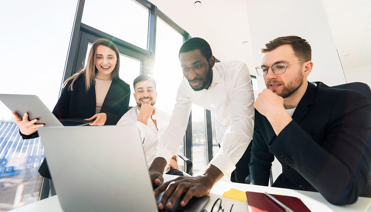 People of different ethnic groups working together in the office on a laptop